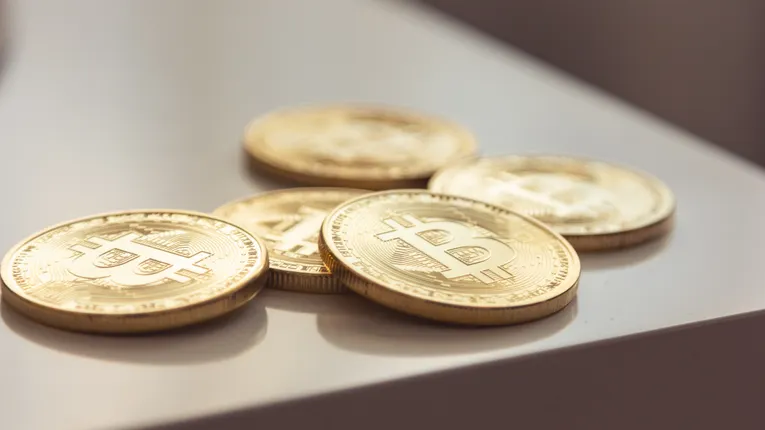 Close-up of shiny gold Bitcoin coins symbolising cryptocurrency storage