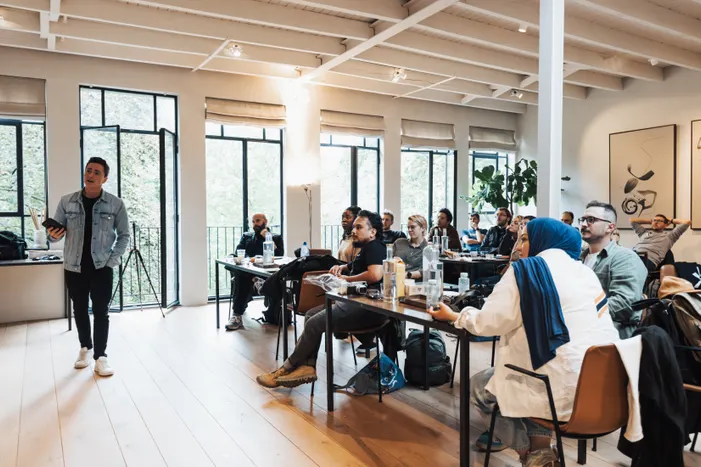 Diverse group attending a workshop, focused on a speaker presenting