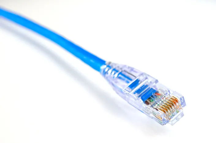 Close-up of blue ethernet cable against white background